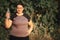 Overweight woman drinking water after jogging