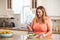 Overweight Woman Eating Healthy Meal And Using Mobile Phone