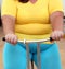 Overweight woman exercising on bike simulator