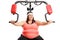 Overweight woman exercising on a multifunctional machine