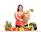 Overweight woman with a groceries bag behind a table with fruit