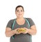 Overweight woman with hamburger and measuring tape