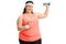 Overweight woman lifting a small dumbbell and pointing