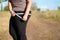 Overweight woman measuring hips with measure tape