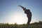 Overweight woman practicing yoga outdoors