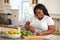 Overweight Woman Preparing Vegetables in Kitchen