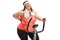 Overweight woman riding an exercise bike and experiencing back p