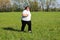 Overweight woman running on meadow