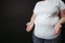 Overweight woman shrugging her hands in perplexity