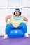 Overweight Woman Sitting On Exercise Ball