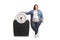 Overweight woman standing next to a medical scale and smiling