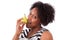 Overweight young black woman eating an pear - African people