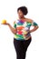 Overweight young black woman holding an orange - African people