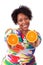 Overweight young black woman holding orange slices - African pe