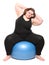 Overweight young woman with blue ball.