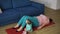 Overweighted woman doing abdominal exercises while her baby playing next to her