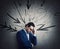 Overwhelmed businessman under pressure suffers headache and anxiety. High tension, dismay concept. Fatigue business person and