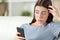 Overwhelmed girl discovering mistake on smart phone