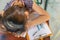 Overworked Asian lady falling asleep on chart document on table