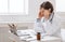 Overworked male doctor suffering from headache at workplace