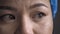 Overworked Medic feels stress after a long overtime. Super close up shot of tired doctor eyes. Woman wearing protective