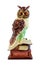 Owl as symbol of wisdom and knowledge. Decorative item, statuette of owl on stack of books. Isolated, white background