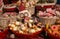 Owl with santa hat in the basket with cake at the interior of Christmas shop