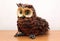 Owl straw decorative object on wooden shelf