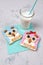 Owl toasts with cream cheese, fruits and cereals with glass of milk, food for kids idea