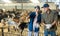 Owner of livestock farm tells the hired worker where to clean barn