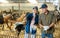 Owner of livestock farm tells the hired worker where to clean barn