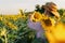 Owner of a sunflower farm inspects the harvest