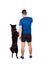 Owner training his obedient border collie dog standing on hind paws isolated over white background. Human and pet friendship.