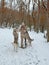 Owner with two malamute dogs walking on the snow