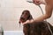 Owner washing Irish Setter dog in bathtub