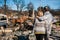 Owners, checking burned and ruined house and yard after fire