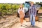 Owners of vineyard with basket full of grapes