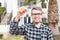 Ownership, real estate, property and tenant concept - Portrait of a cheerful young man holding key from new home