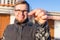 Ownership, real estate, property and tenant concept - Portrait of a cheerful young man holding key from new home