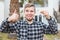 Ownership, real estate, property and tenant concept - Portrait of a cheerful young man holding key from new home