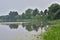 Oxbow lake and the floodplain by the river on a gloomy, cloudy evening. River, Day