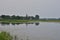 Oxbow lake and the floodplain by the river on a gloomy, cloudy evening. River, Day
