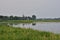 Oxbow lake and the floodplain by the river on a gloomy, cloudy evening. River, Day