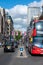 Oxford Street decorated with Union Jack flags for the Jubilee and London Black Taxis and a Red Double Decker Bus in the foreground