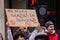 OXFORD STREET, LONDON, ENGLAND- 20 March 2021: Protester holding a `NO MORE MASKS IN SCHOOLS` placard at an anti-lockdown protest