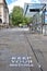 Oxford, UK- 06 13 2020: A bus passenger wears a mask in St Giles with social distancing signs painted on the pavement.