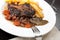Oxtail stew with carrots and fries