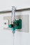 Oxygen flow meter plugged in the green outlet on white wall