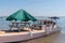 Oyster boats in the Bassin Arcachon Bay with wooden table and umbrella