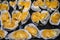 Oysters in a pan in a creamy sauce and cheese. Against a table background